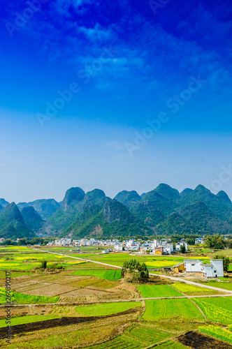 Countryside and mountain scenery with blue sky background 