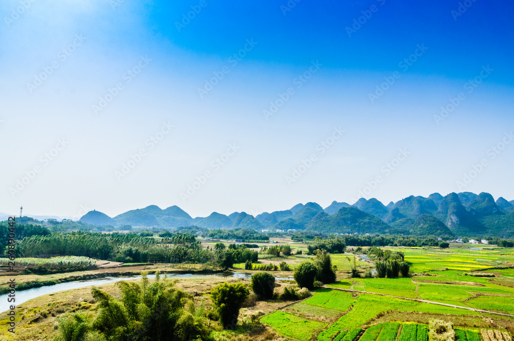 Countryside and mountain scenery with blue sky background 