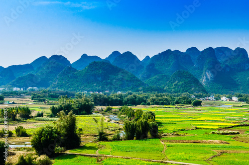 Countryside and mountain scenery with blue sky background 