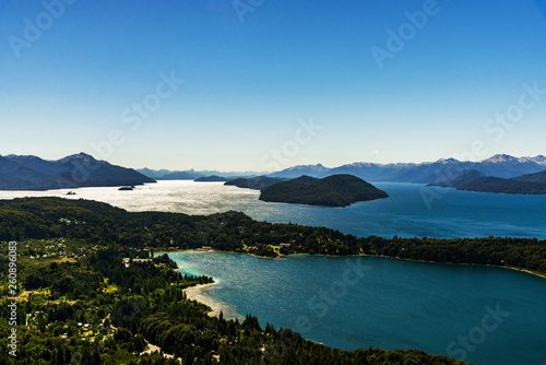 Fototapeta Naklejka Na Ścianę i Meble -  Scenic aerial nature colorful landscape photo of blue aquamarine lakes, rivers, Andes mountains, and green tree forest in Patagonia, Argentina