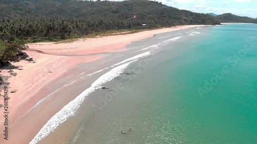 Couple swimming at empty beach