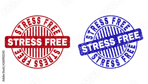 Grunge STRESS FREE round stamp seals isolated on a white background. Round seals with grunge texture in red and blue colors. Vector rubber overlay of STRESS FREE tag inside circle form with stripes.