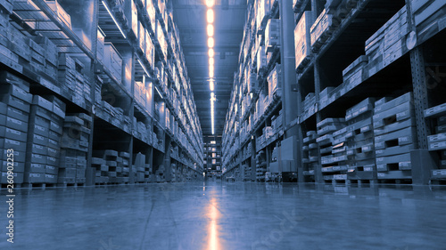 Huge product warehouse with tall shelves and lots of boxes stack over each other and bright led lights from top ceiling. Color tone adjusted photo