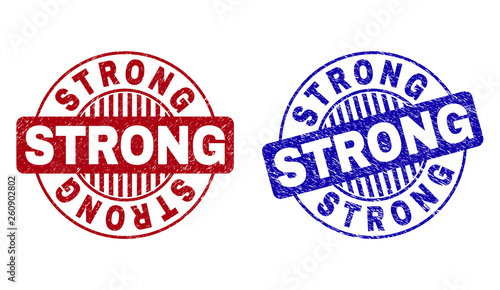 Grunge STRONG round stamp seals isolated on a white background. Round seals with grunge texture in red and blue colors. Vector rubber watermark of STRONG tag inside circle form with stripes.