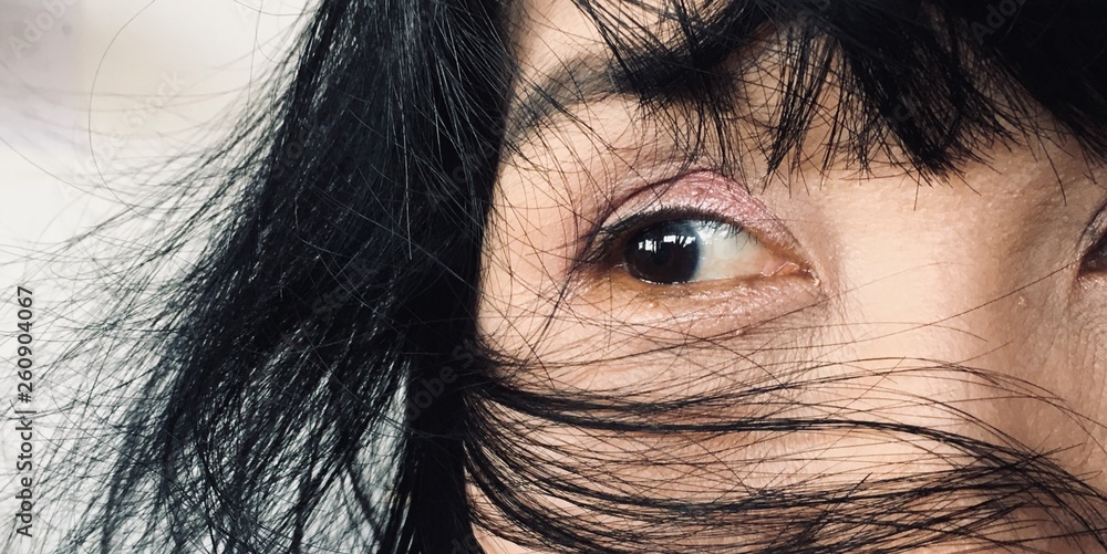 Fototapeta premium The image of a woman's eye is looking to the side. The conceptual beauty makeup