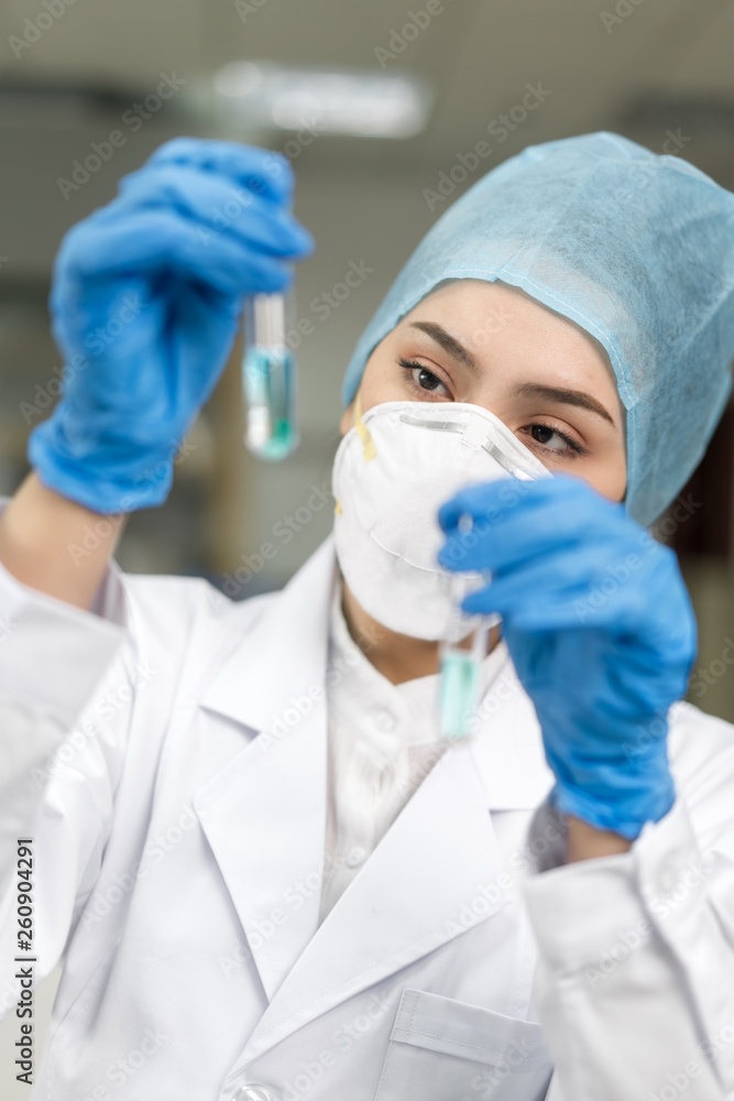 Female scientist looking at the scientific sample in the CDC laboratory Female scientist looking at the scientific sample in the CDC laboratory