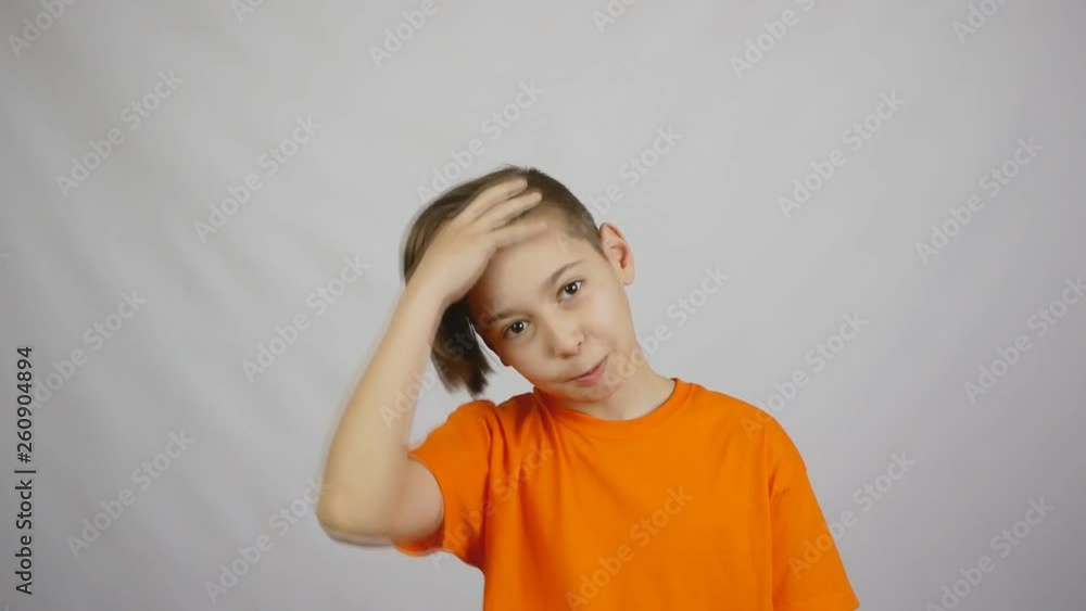 young handsome guy, boy with long bangs, shaking his head, on a light background. Slow motion young handsome guy, boy with long bangs, shaking his head, on a light background. Slow motion
