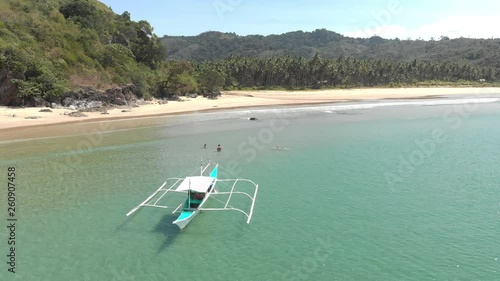 Friends in the turquoise ocean next to boat