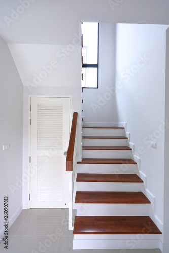 brown wooden stair and white wall in residential house