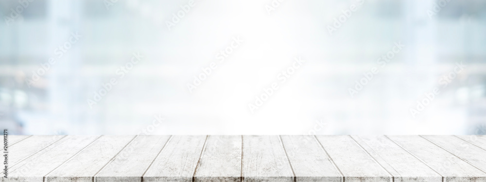 Empty wood table top and blur glass window wall in office building background - can used for display or montage your products. - obrazy, fototapety, plakaty 