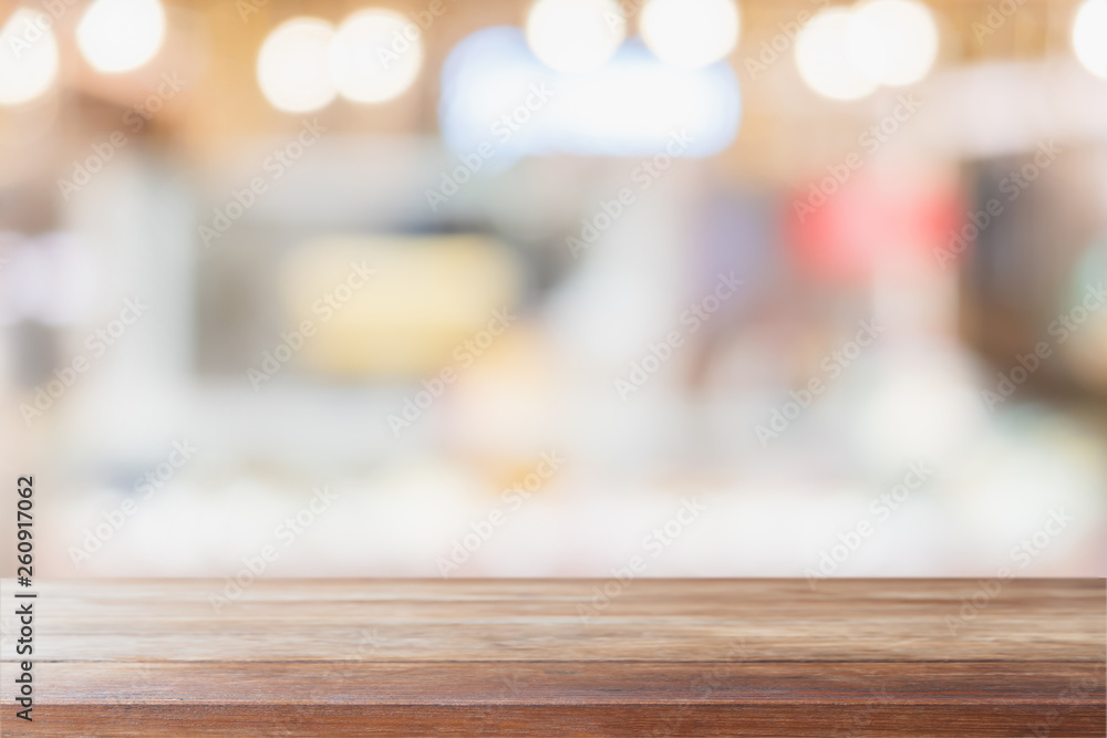 Empty wood table top and blurred restaurant interior background - can used for display or montage your products.