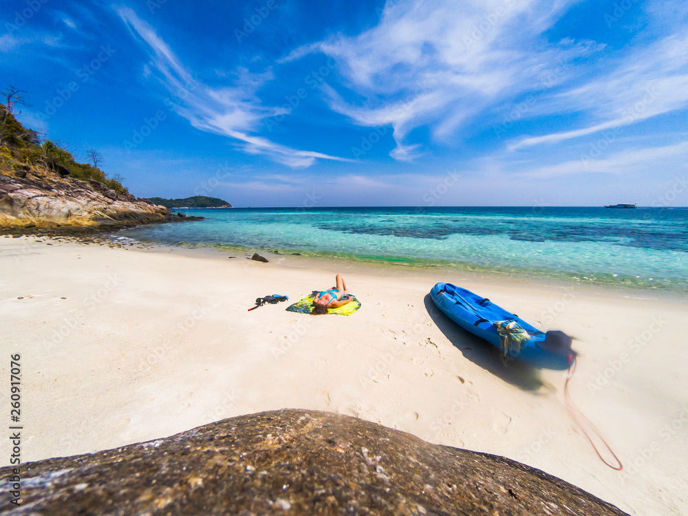 woman with a kayak on an isolated beach in Andaman sea, Koh Lipe - solo travel