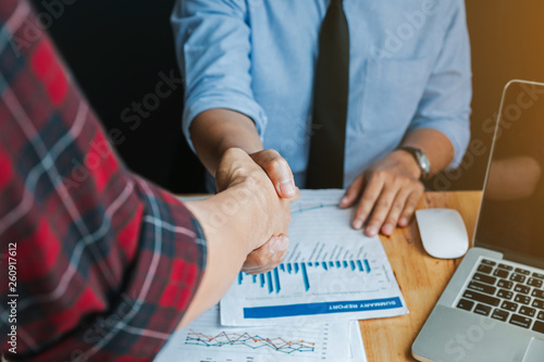 Two business man shaking hands during a meeting in the office, success, greeting and partner concept