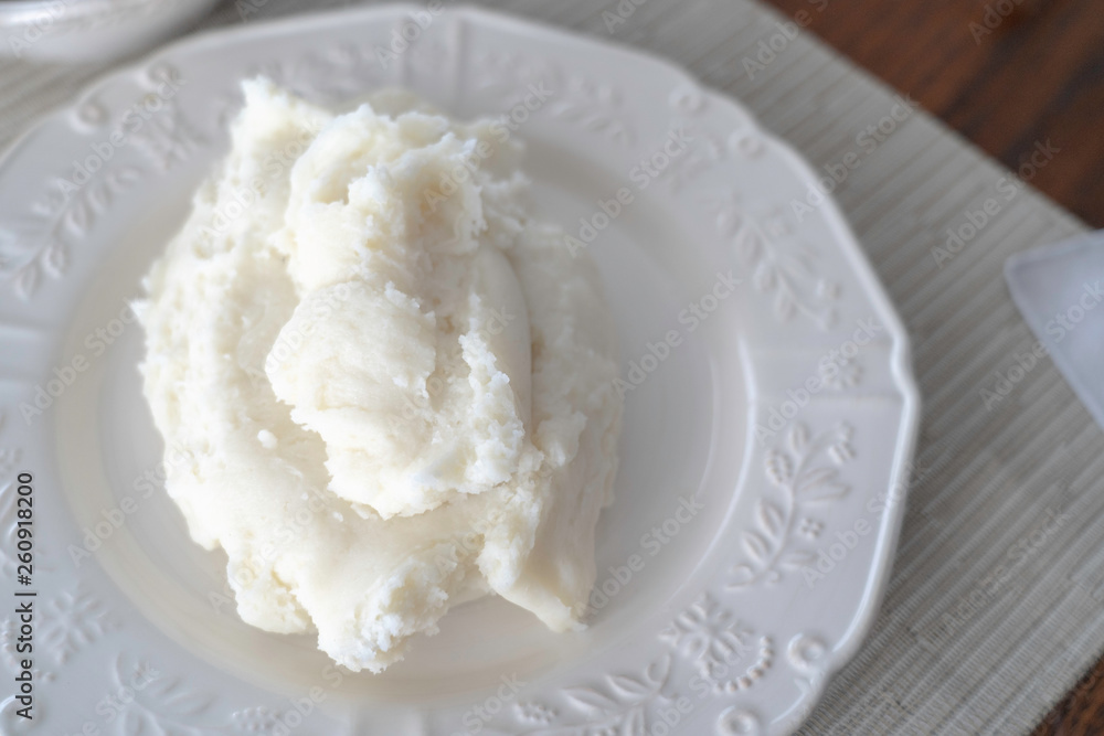 Nigerian Pounded yam on white plate ready to eat Nigerian Pounded yam on white plate ready to eat