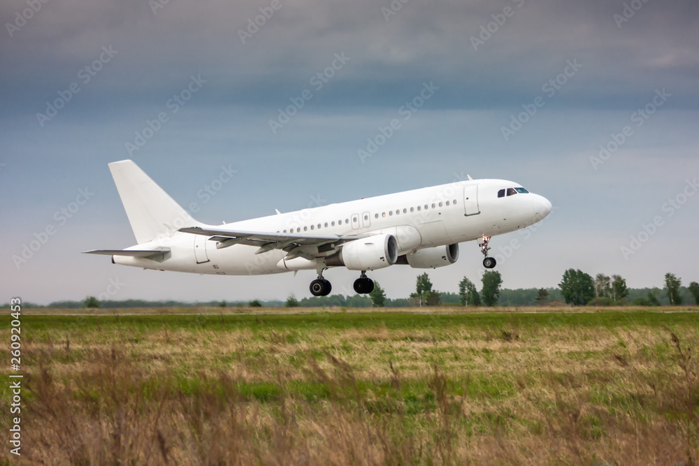 White passenger jet plane in the air on take-off White passenger jet plane in the air on take-off