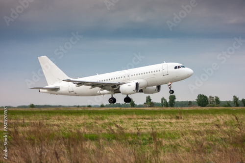White passenger jet plane in the air on take-off