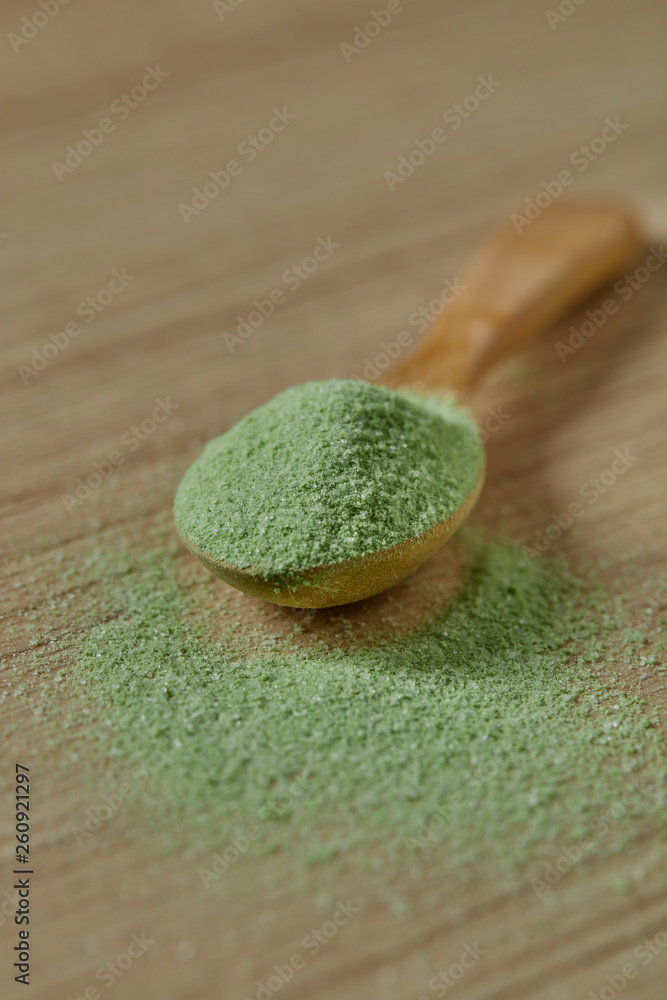 Wooden spoon with powdered matcha green tea