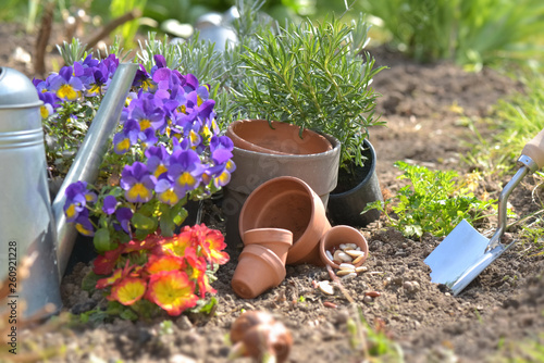 flowerpots and seeds with shovel planting in the soil in a garden in spring