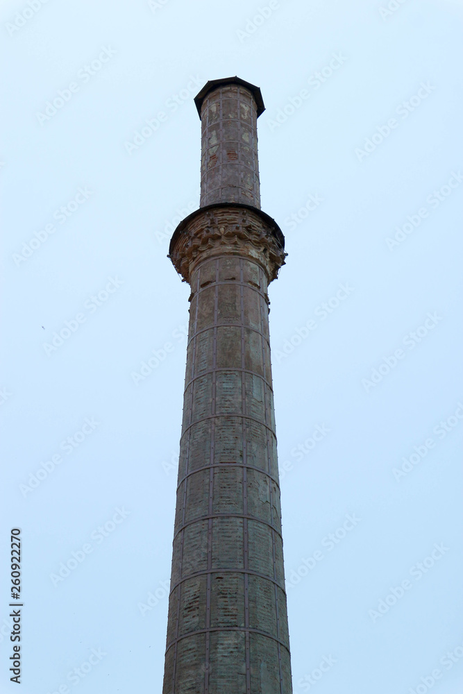 View to tall minaret in Thessaloniki, Greece with blue sky on the background