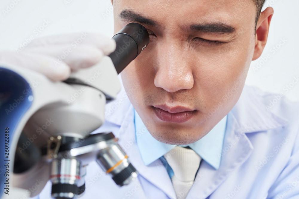 Scientist looking at microscope