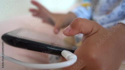 4K Close up charging tablet in hands of a child