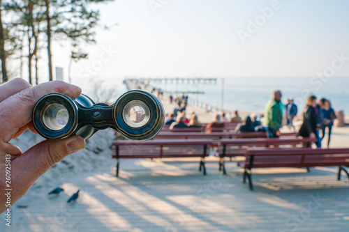 Travel with binoculars. Lithuanian city resort Palanga. View of the Baltic Sea and the pier.