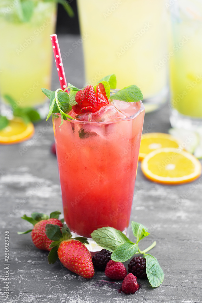 Summer iced drink - tea or juice with strawberry ice and mint. On rustic wooden table, copy space. Summer iced drink - tea or juice with strawberry ice and mint. On rustic wooden table, copy space.