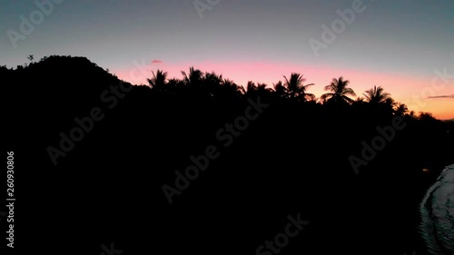 Flyover ocean beach Philippines by sunset