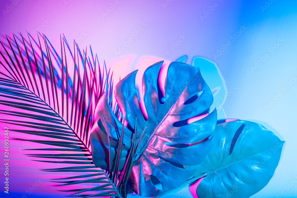 Fototapeta Tropical leaves in vibrant bold gradient holographic neon colors