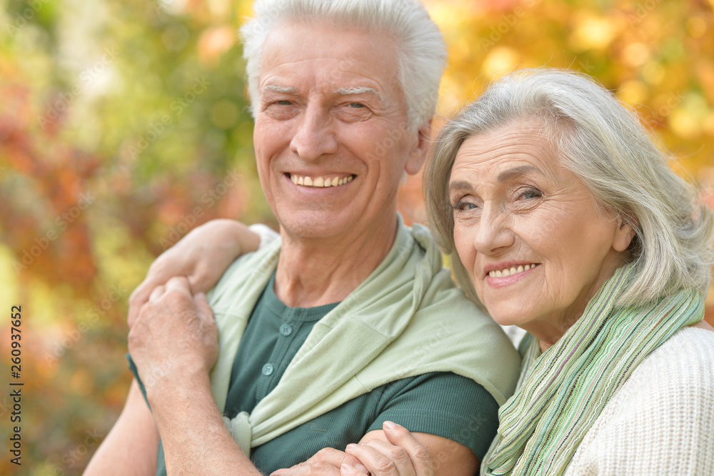 Happy senior couple in autumn park hugging Happy senior couple in autumn park hugging