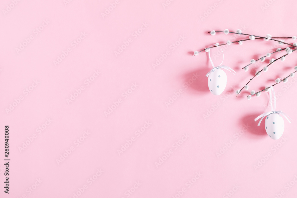 Easter pink composition. Easter eggs and willow branch on pastel pink background. Flat lay, top view, copy space