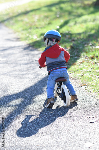 child on a bike with a helmet