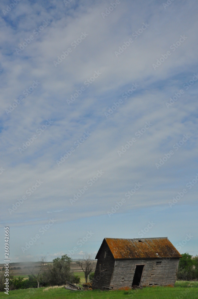 Weathered Barn Under Blue Sky