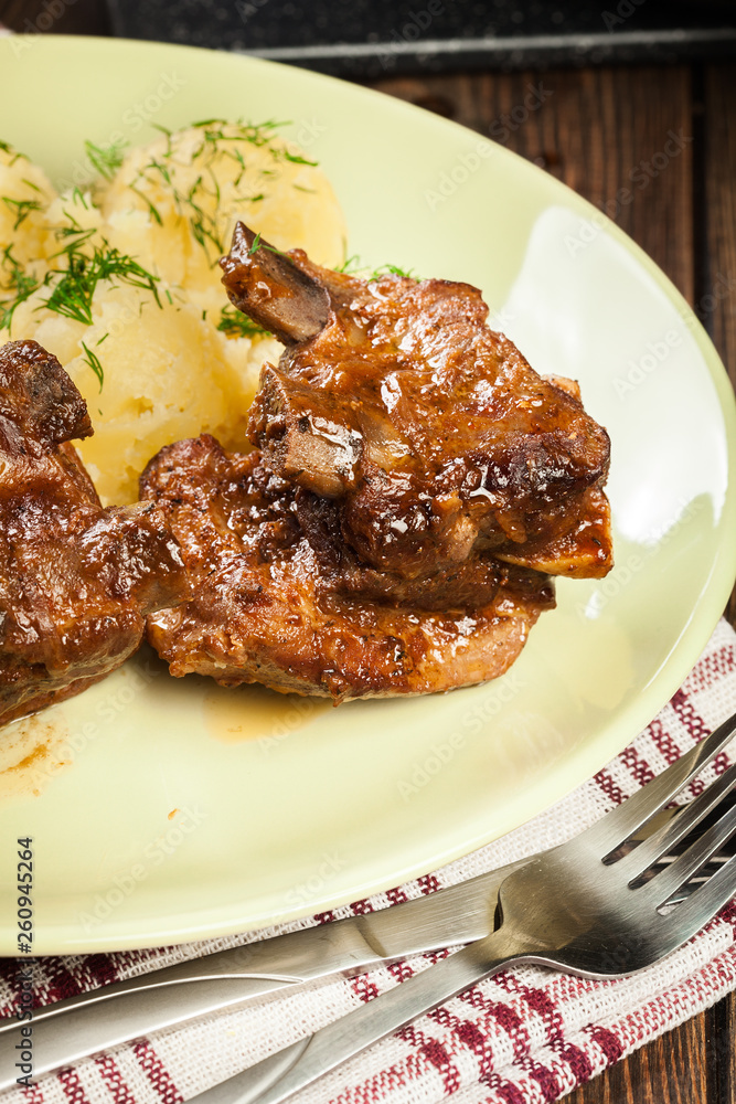 Pork spare ribs served with mashed potatoes and sauce Pork spare ribs served with mashed potatoes and sauce