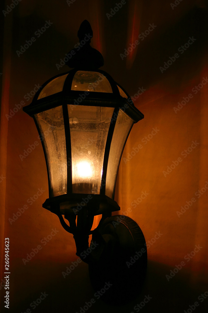 Night. Lantern on the wall