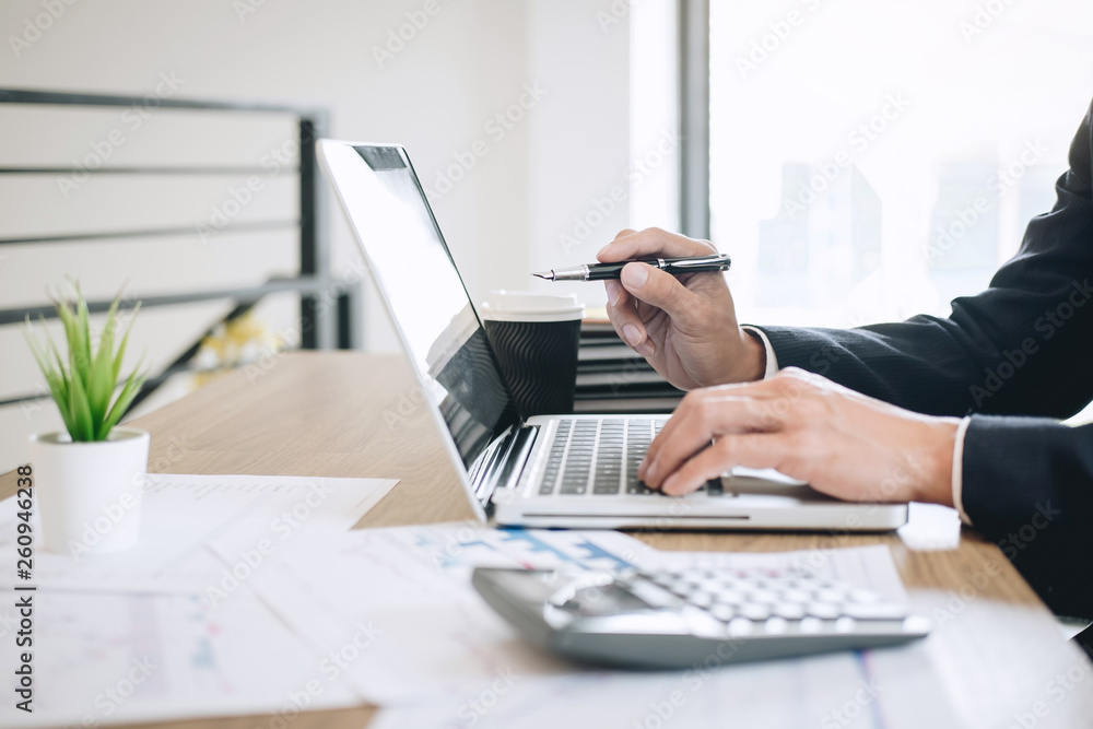 Businessman working new project on laptop computer with report document and analyze, calculating financial data on graph documents, doing finance making notes statistics Businessman working new project on laptop computer with report document and analyze, calculating financial data on graph documents, doing finance making notes statistics