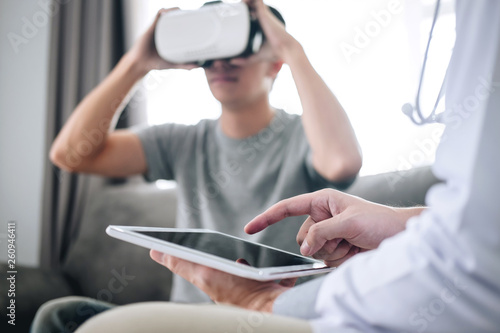 Young asian man patient using virtual reality glasses to see technology to examination physical body patient while doctor explains, 3D gadget technology, VR AR glasses