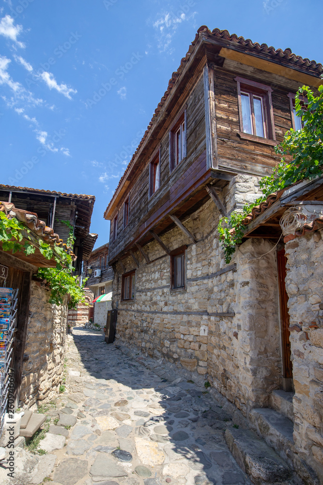 NESSEBAR, BULGARIA, August 9, 2018 - View of a narrow street with traditional Bulgarian wooden houses in old Nessebar