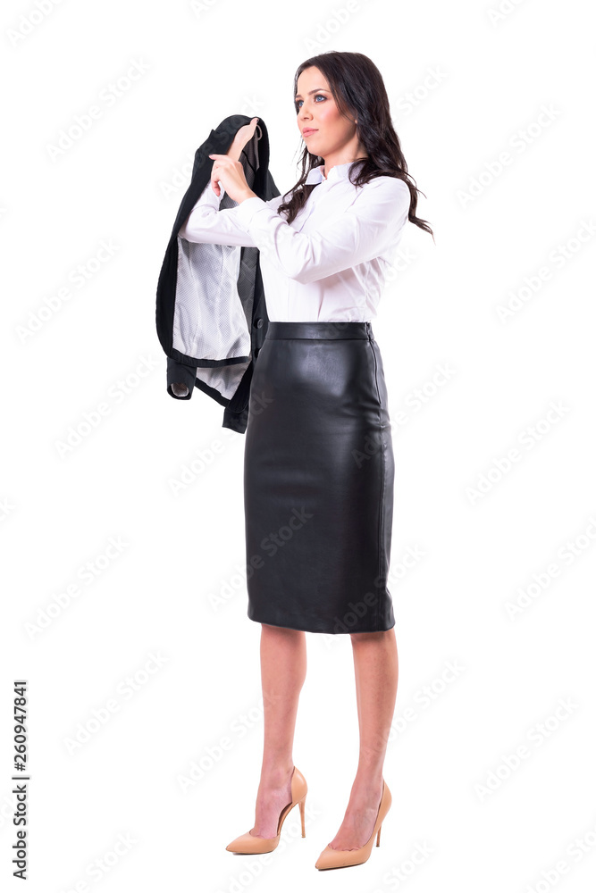 Elegant business woman in formal clothes puts on jacket looking away. Full body isolated on white background. Elegant business woman in formal clothes puts on jacket looking away. Full body isolated on white background.