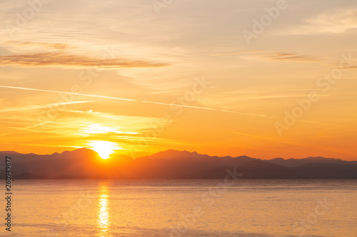 Summer sunrise on coast  Corfu island  Greece. Beach with perfect views of the mainland Greece mountains.