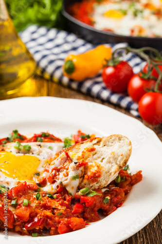 Shakshouka, dish of eggs poached in a sauce of tomatoes, chili peppers, onions