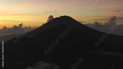 Slow drone aerial view at dawn of mountains and fluffy clouds in Bali, Indonesia. Seq 1. photo