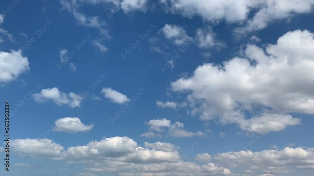 White clouds move rapidly across the blue sky. Fast motion. Time lapse. White clouds move rapidly across the blue sky. Fast motion. Time lapse.