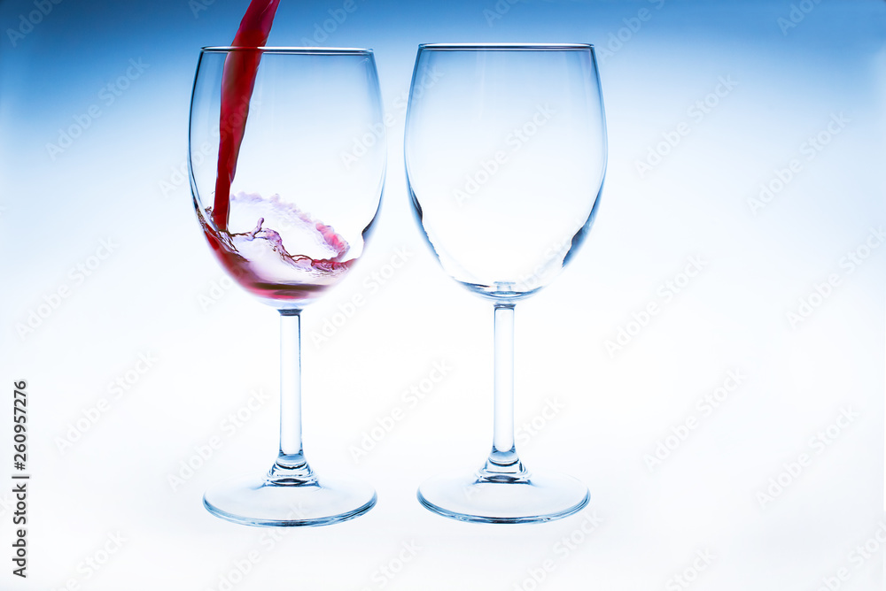 Splash red wine glass against a white background