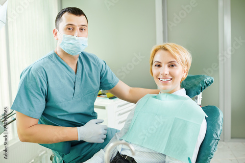 Dentist and patient are smiling