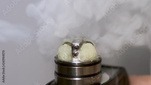 Closeup of a Vape Mod igniting. Cotton Coil Smoke photo