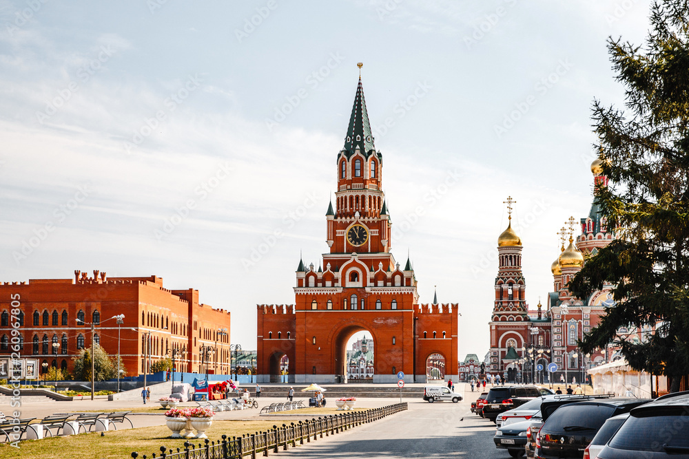 Fototapeta premium City of Yoshkar-Ola, Republic of Mari El, Russian Federation. August 31, 2018. The Voskresenskaya embankment. Blagoveshchensky (Spasskaya) Tower