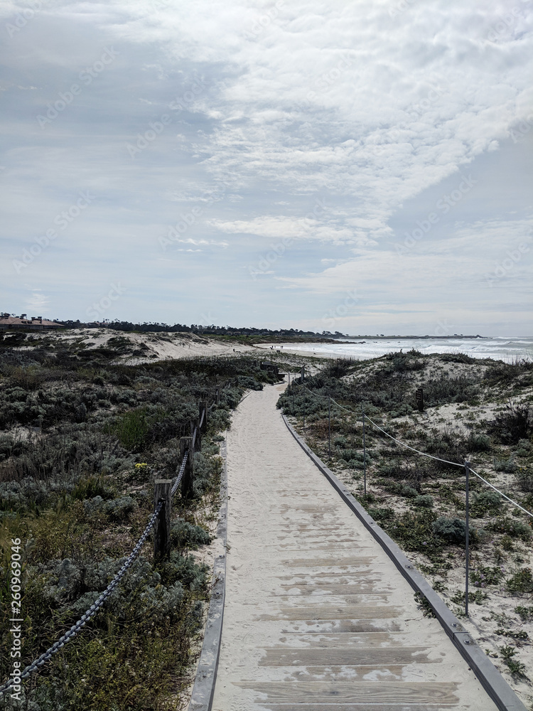 Ocean beach California  sand rock wooden walkway to the beach