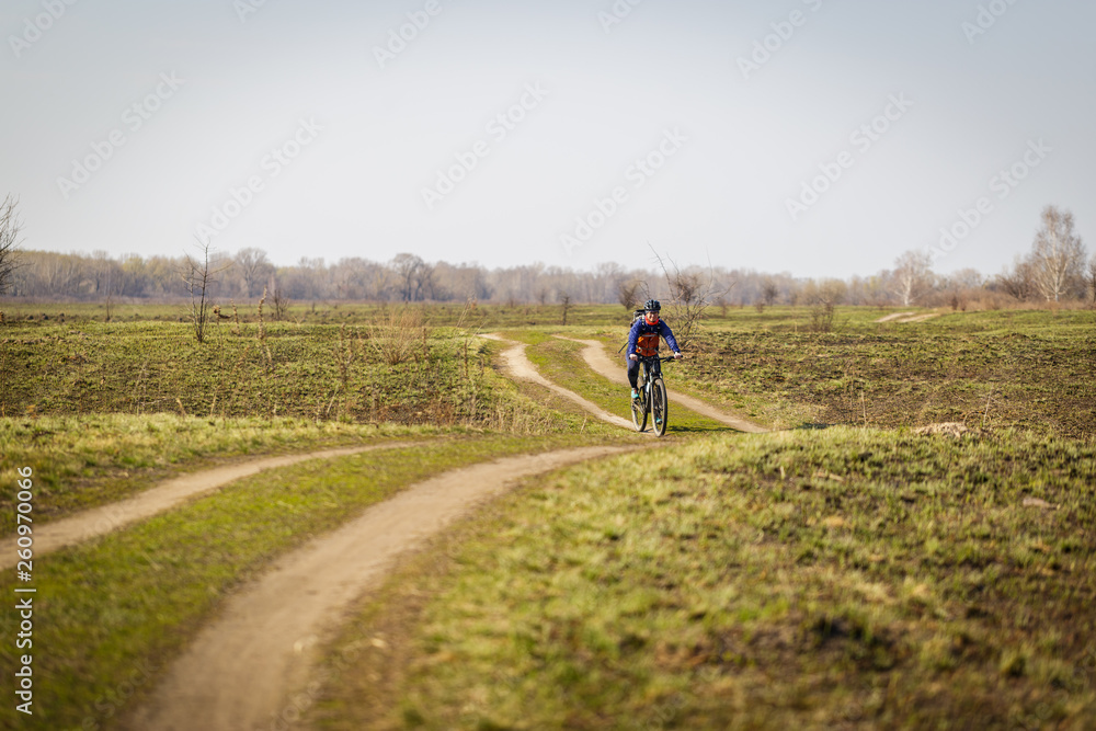 woman cyclist riding a bicycle in the field
