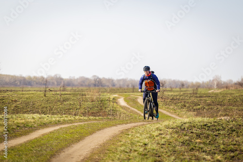 woman cyclist riding a bicycle in the field